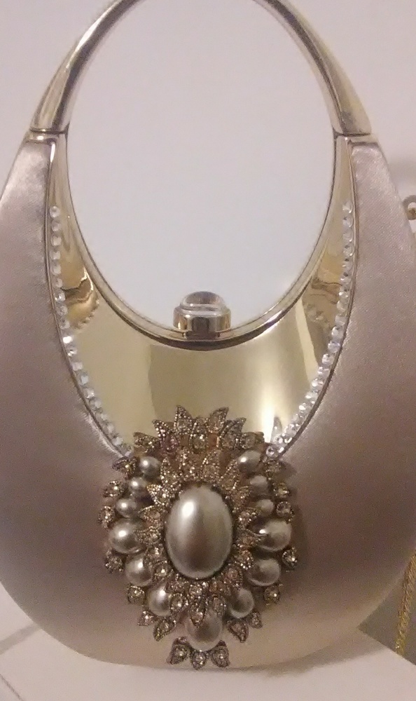 A gold  colored satin pocketbook